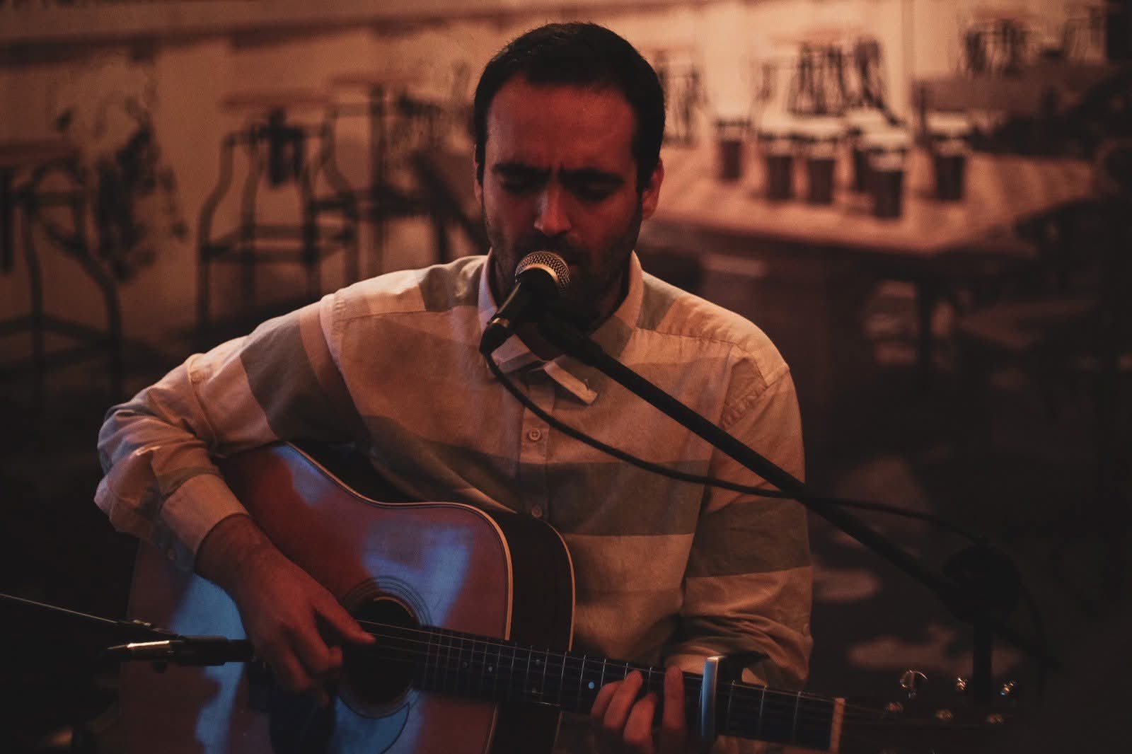 Ilko Birov singing and playing acoustic guitar in Plovdiv